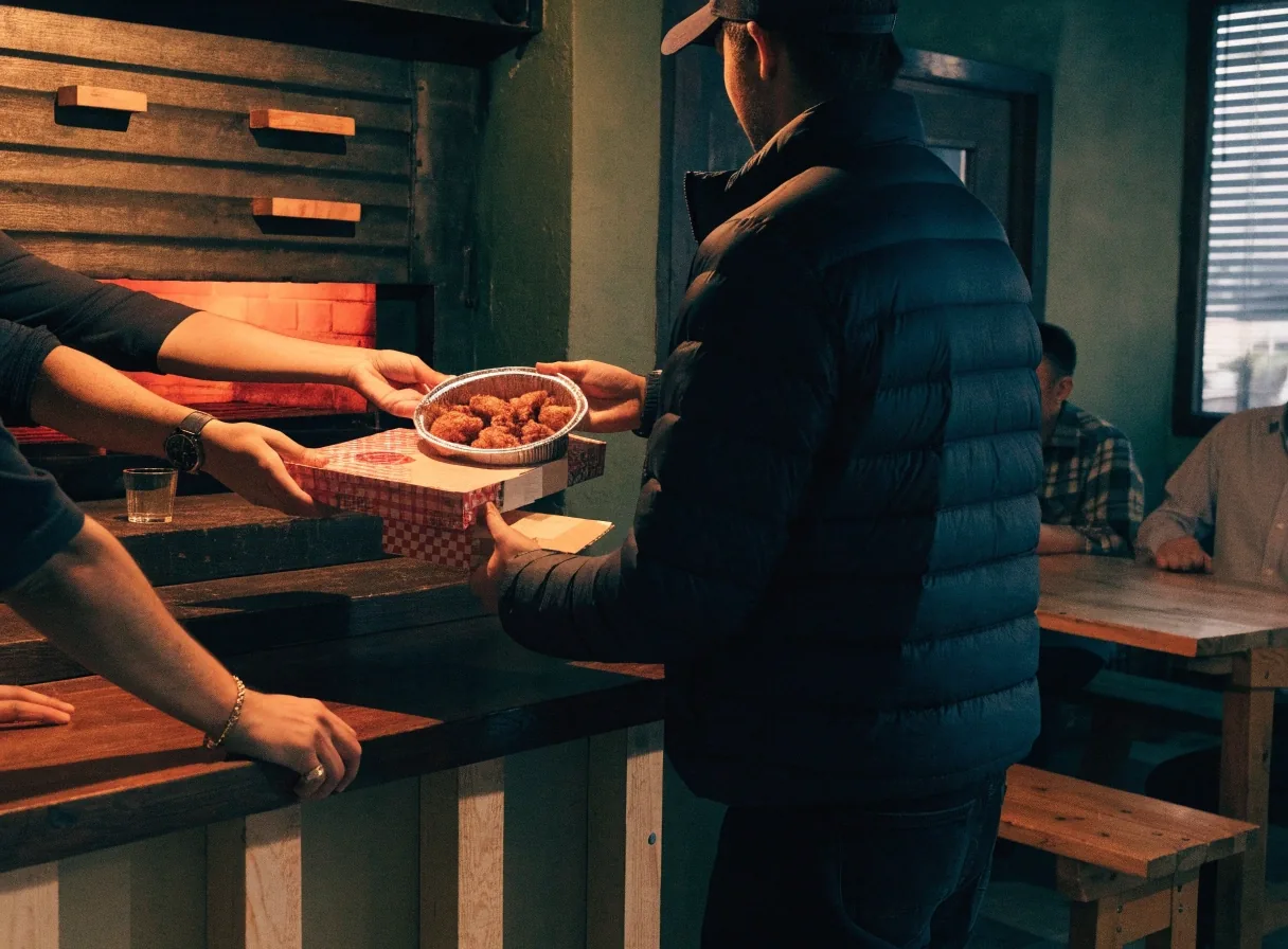Coal-fired pizza and wings served for a commuter dinner