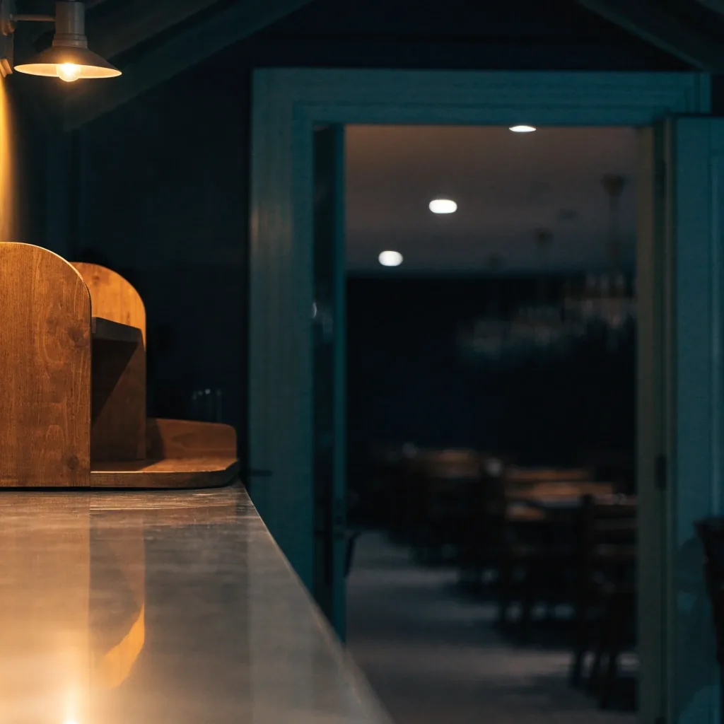 Quiet dining room with warm lamp light on the counter
